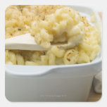 Macaroni cheese in baking dish with wooden square stickers
