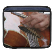 male hand holding pick on acoustic guitar iPad sleeves