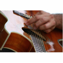 male hand holding pick on acoustic guitar photo cutout