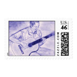 Male playing acoustic guitar while sitting Purple Postage Stamps