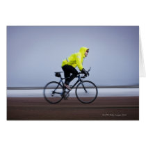 Man bicycles on a cold and foggy winter day. greeting cards