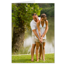 Man helping woman golf cards