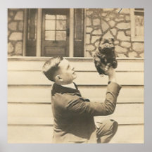man holding up small animal  with one hand poster
