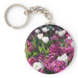 Mixed spring flowers in flower bed keychain