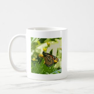 Monarch butterfly on a green and yellow plant mug