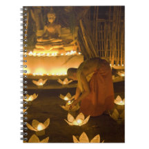 Monks lighting khom loy candles and lanterns for note book