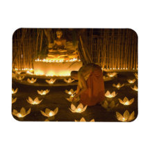 Monks lighting khom loy candles and lanterns for rectangular magnet