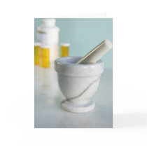 Mortar and pestle, pill bottles in background card