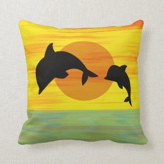 Mother and baby dolphin leaping out of the sea throw pillows