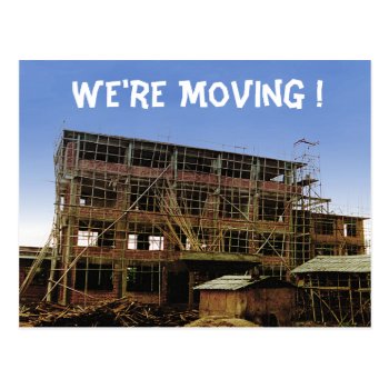 We’re moving funny postcard- A building under construction, its walls made of brick and covered in bamboo scaffolding