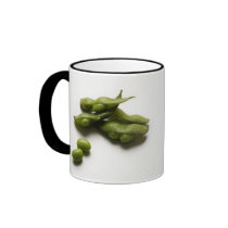 multiple green edamame beans with pea pod broken coffee mug