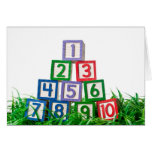 Number blocks stacked on grass greeting cards