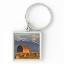 Old barn framed by hay bales and dramatic keychains