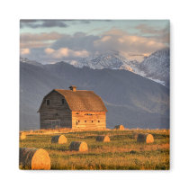 Old barn framed by hay bales and dramatic fridge magnets