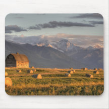 Old barn framed by hay bales and dramatic mouse pad