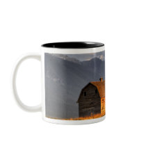 Old barn framed by hay bales and dramatic coffee mugs