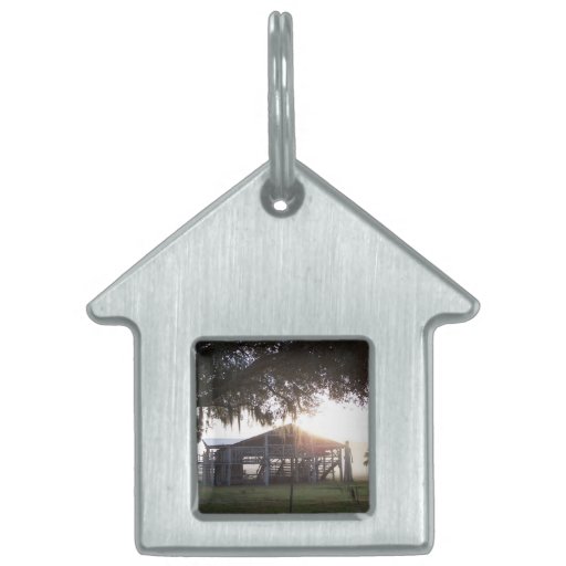 Old ranch building under trees with man statue pet tag