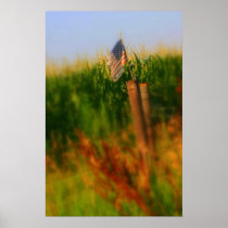 Old tattered American Flag on a wooden fence post Poster