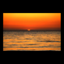 Orange sun setting in orange waters posters