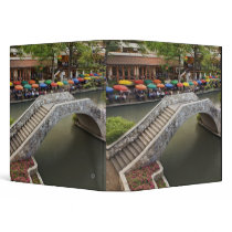 Outdoor cafe along River Walk and bridge over 2 Binders