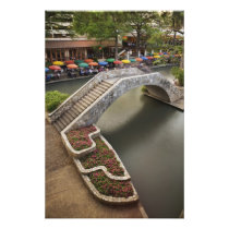 Outdoor cafe along River Walk and bridge over