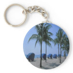 Palm trees, and  cabanas on a beach, on a keychain