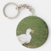 Pekin duck with open bill on green grass keychains