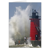 People on jetty watch large breaking waves in