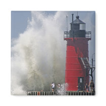 People on jetty watch large breaking waves in