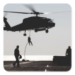Personnel fast-rope out of an SH-60F Sticker