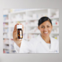 Pharmacist in drug store holding out pill bottle posters