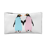 Pink and blue Penguins holding hands. Makeup Bags