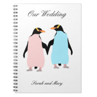 Pink and blue Penguins holding hands. Note Book