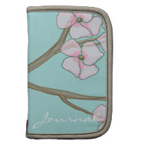 Pink dogwood flowers on turquoise folio planners