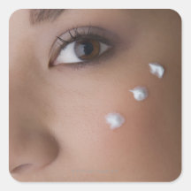 Portrait of a young woman with cream on her sticker