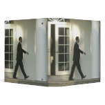 President Barack in deep thought as he walks binders