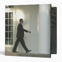 President Barack in deep thought as he walks Binders