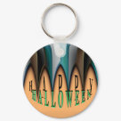 round_keychain - Halloween design with bronze and teal striped arches that look like pointy teeth on an orange background. Inspired by Tim Burton's "Nightmare Before Christmas" Text: Happy (chiseled black) Halloween (rubbly acid green)