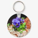 Purple pansy flowers near rocks in Colorado keychain