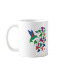  - The simple graphic shapes and the  brilliant colors of the hummingbird  and trumpet shaped flowers blend  together in shades of green, pink,  orange and fuschia. This vibrant colorful artwork is featured on  hummingbird clothing and gifts. Delight your hummingbird  lover today with this beautiful gift.: Sizes  Available colors: white