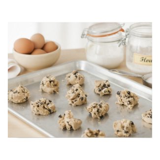 Raw cookies on baking tray posters