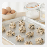 Raw cookies on baking tray square stickers