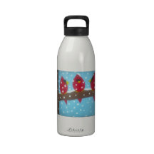 RED CARDINALS IN THE SNOW DRINKING BOTTLES