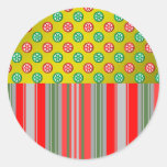 Red green snowflakes in circles on gold stripes round sticker