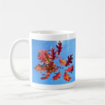 Red maple leaves against blue sky mug