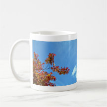 Red maple leaves against blue sky mug