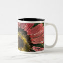 This painting of a red sunflower design is made on a coffee mug