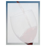 Red wine poured into wine glass letterhead