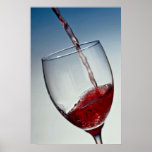 Red wine poured into wine glass poster