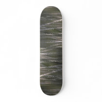Reflection of tree trunks in a beaver pond skate decks